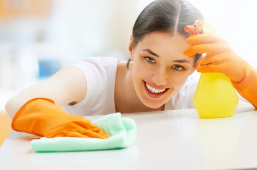 Cleaner preparing a Kennington property for move-in with detailed surface cleaning