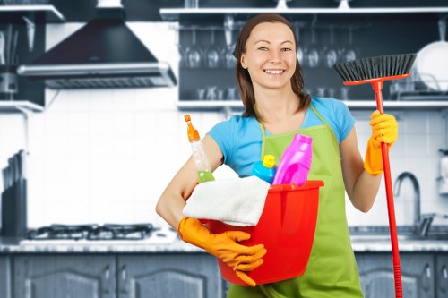 Kitchen surfaces and appliances being cleaned in a Kennington home