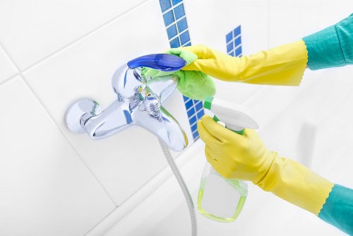 Professional cleaner working in a modern Kennington flat