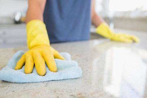 Local cleaner treating sofa stains in a Kennington flat